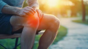 Man sitting on bench, suffering from knee injury