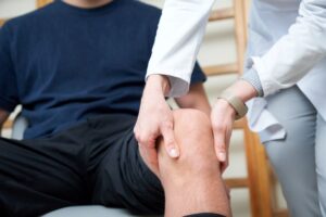 Doctor examining a patient’s knee